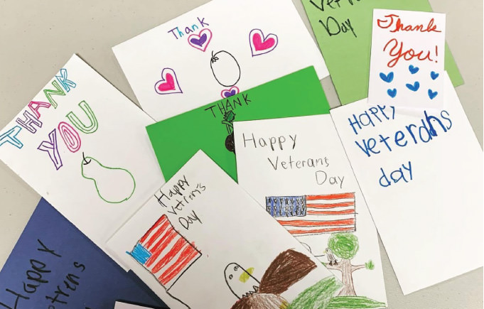 Thank you veterans cards hand-drawn by kids with American flags, hearts, fruit, and an eagle