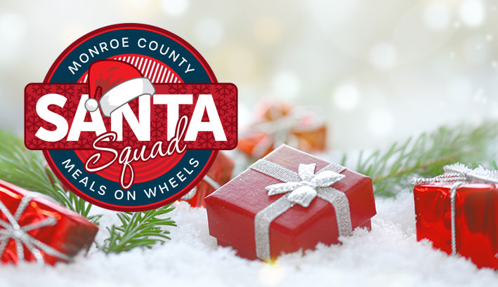 Santa Squad logo with red packages with silver bows in the snow with green pine needles and silver sparkles in the background