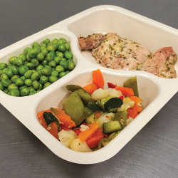 Daily meal deliveries features tray with chicken, peas, and mixed vegetables