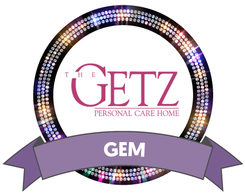 Getz Personal Care logo surrounded by a black outer circle filled with gem sparkles, and a purple Gem Sponsor ribbon at the bottom